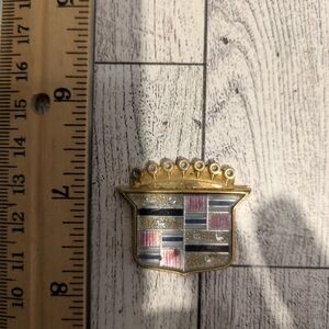 cadillac Gold and Silver Car Emblem with Multicolor Accents